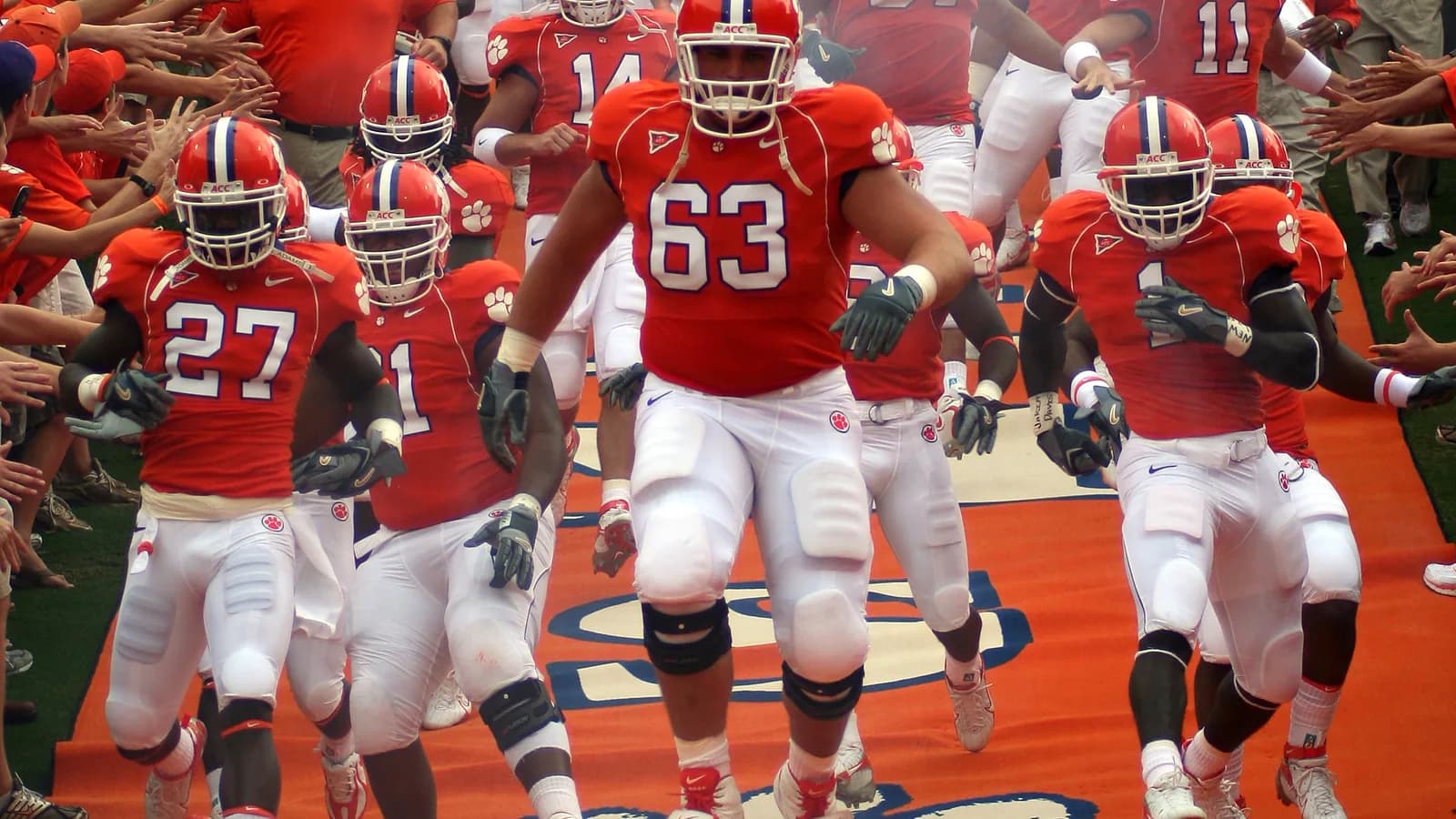 Clemson players run down the hill into Memorial Stadium before a game.