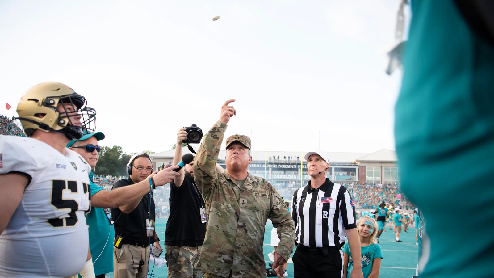 Coastal Carolina and Army players gather for the pregame coin toss.