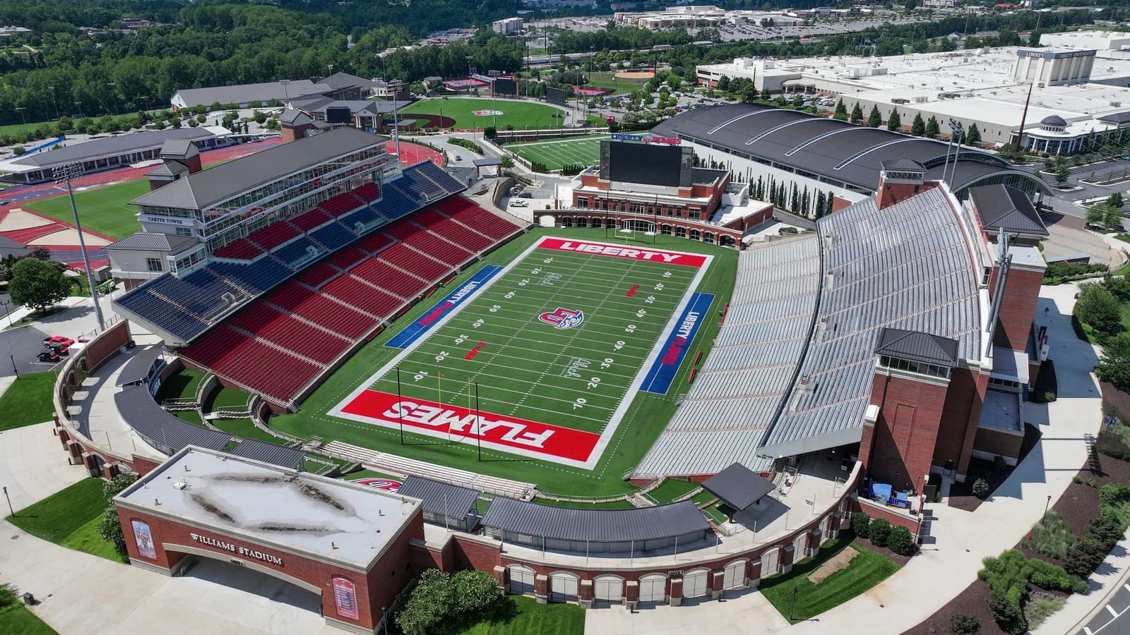 An aerial view of Liberty's Williams Stadium with Flames wordmarks on the field.