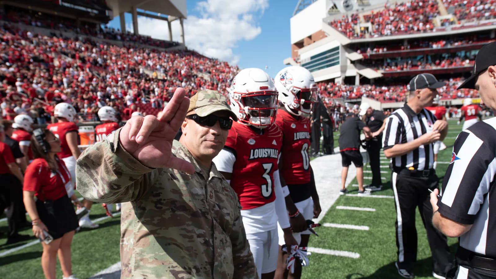 Louisville players take the field before a 2024 home game.