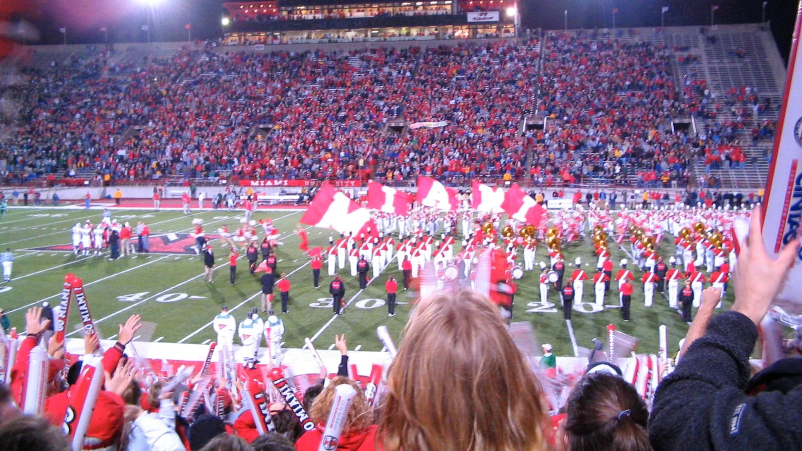 Miami University football players enter a crowded stadium in 2003.