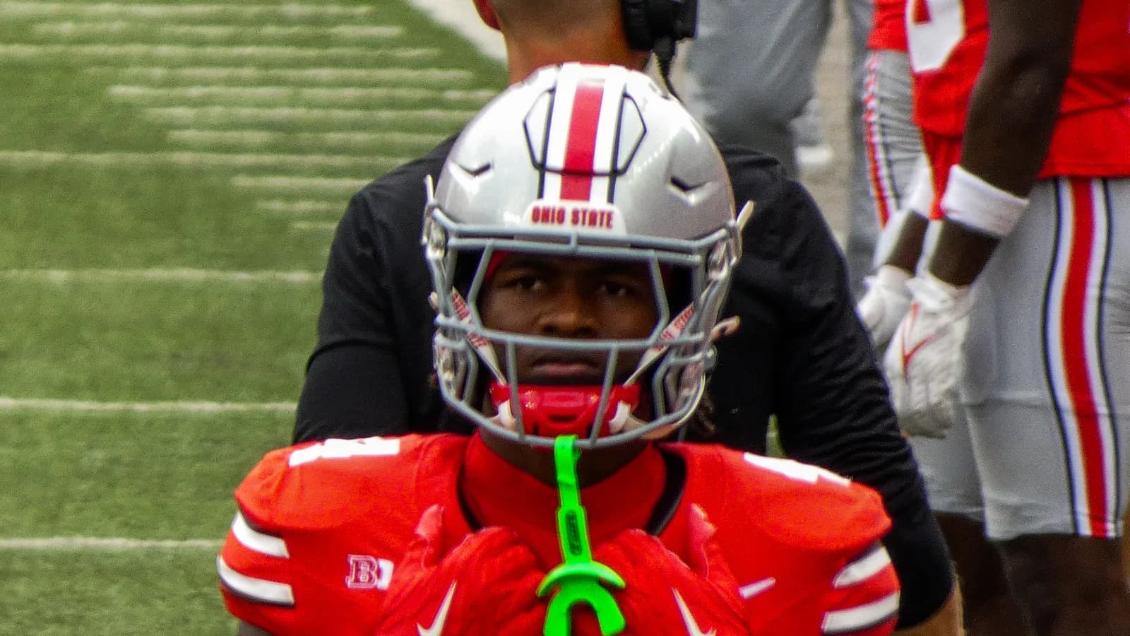Ohio State wide receiver Jeremiah Smith stands on the sideline in uniform.