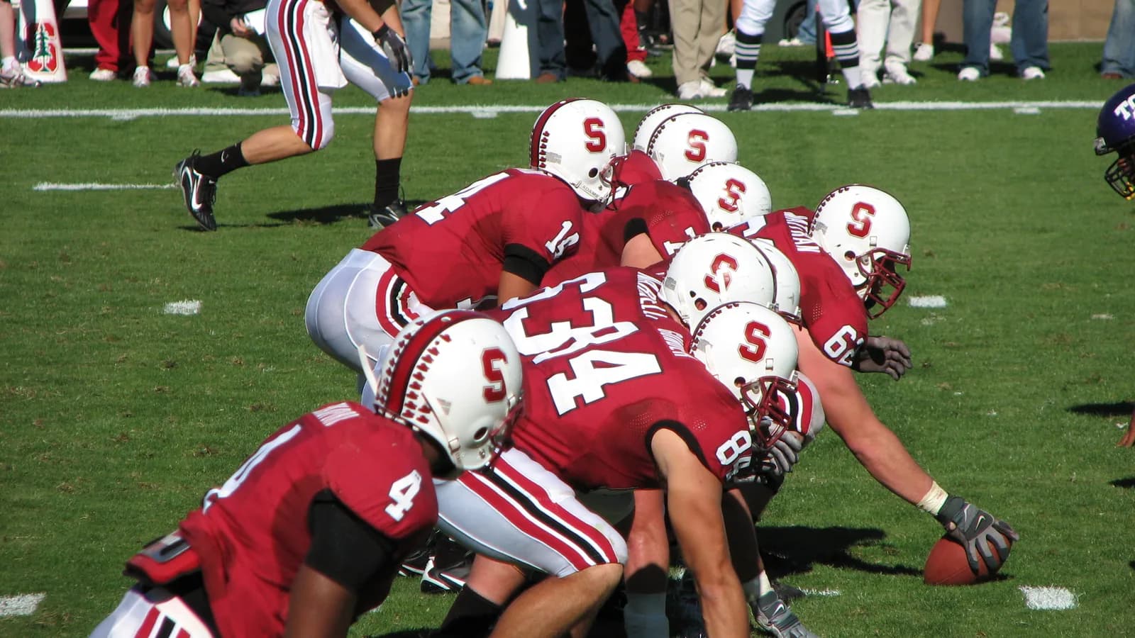 Stanford's offense lines up in cardinal-and-white uniforms.