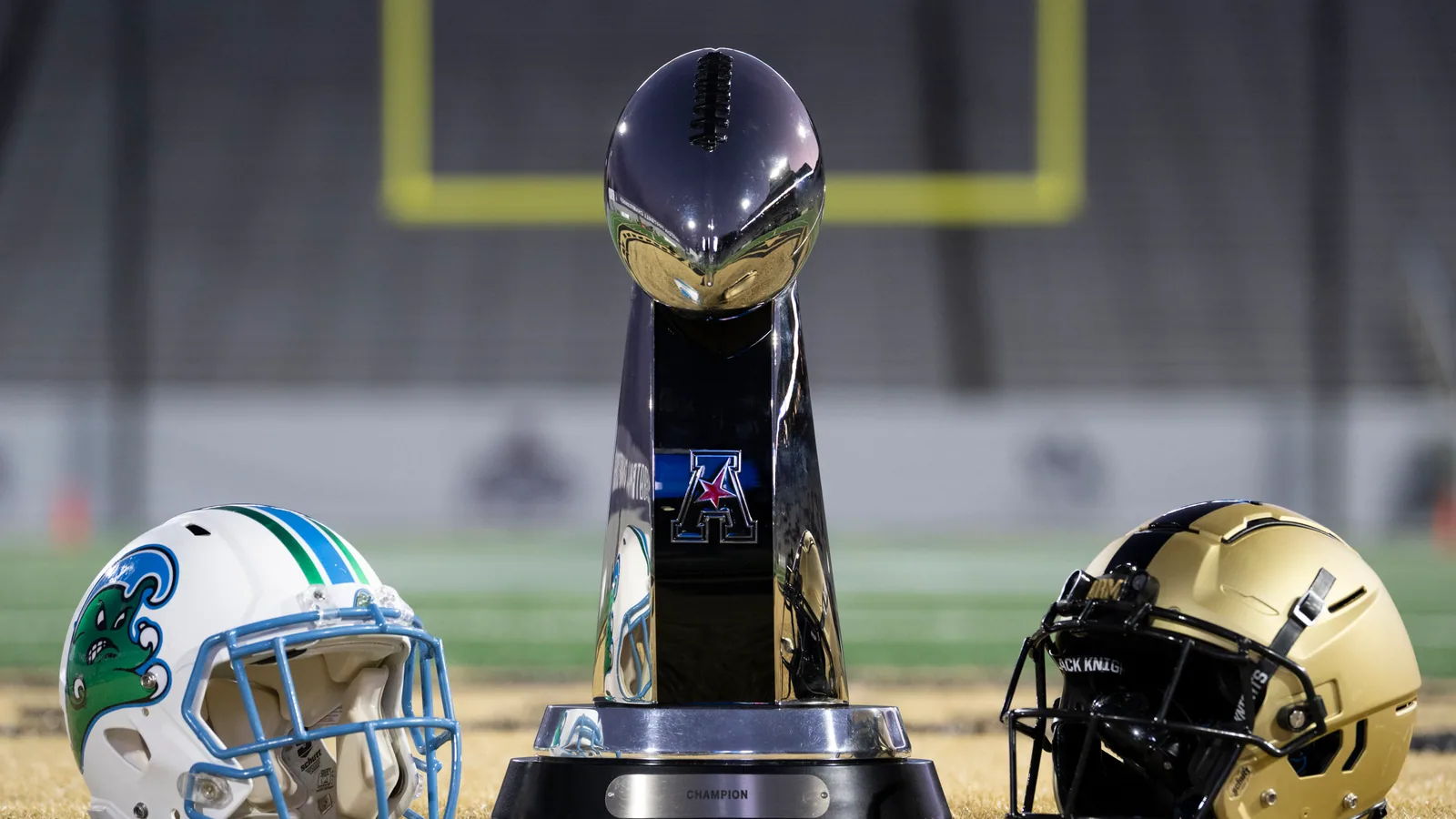 A Tulane helmet and Army helmet flank the American Conference championship trophy.