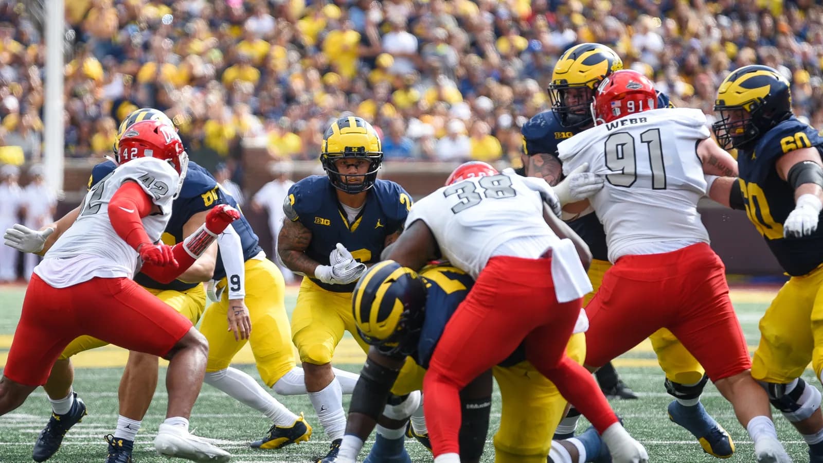 UNLV defenders line up against Michigan's offense during a 2023 game.