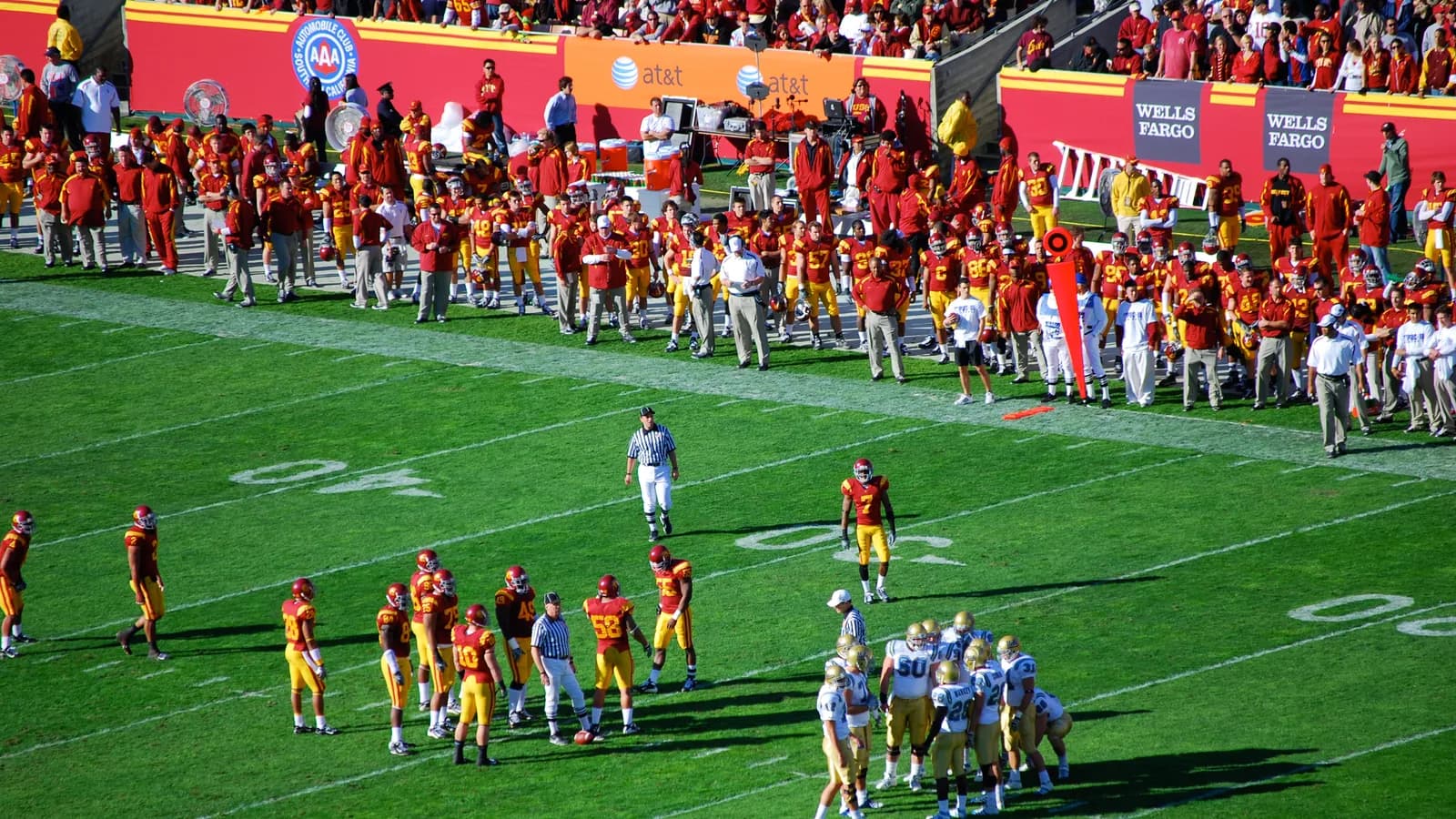 Players and staff line the sideline during the 2007 UCLA-USC football game.