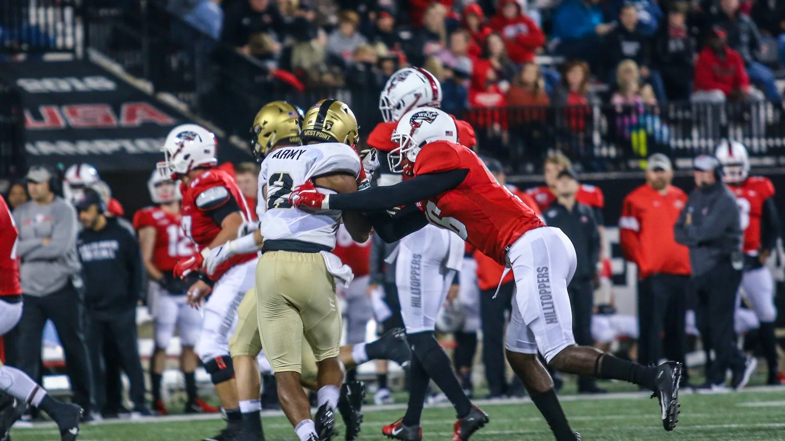 A Western Kentucky defender tackles an Army ball carrier.