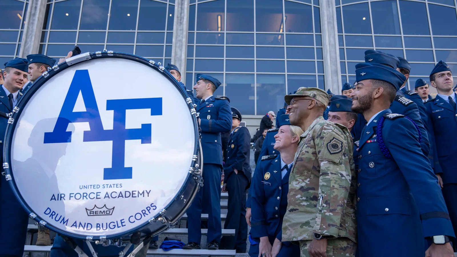 Air Force personnel watch the 2024 game against Army beside an Air Force sign.