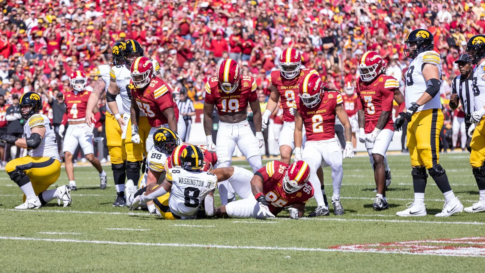 An Iowa State defender stands over an Iowa player during the 2025 Cy-Hawk game.