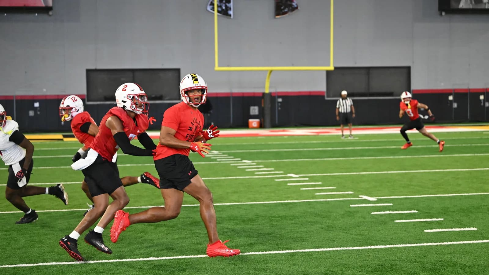 Maryland football players run a conditioning drill in College Park.