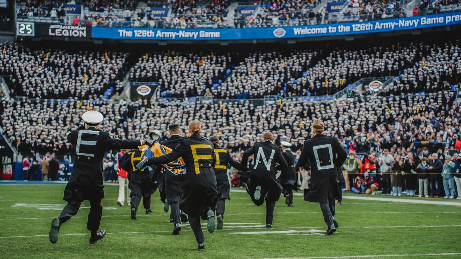 Navy and Army meet at midfield before the 2025 Army-Navy game.