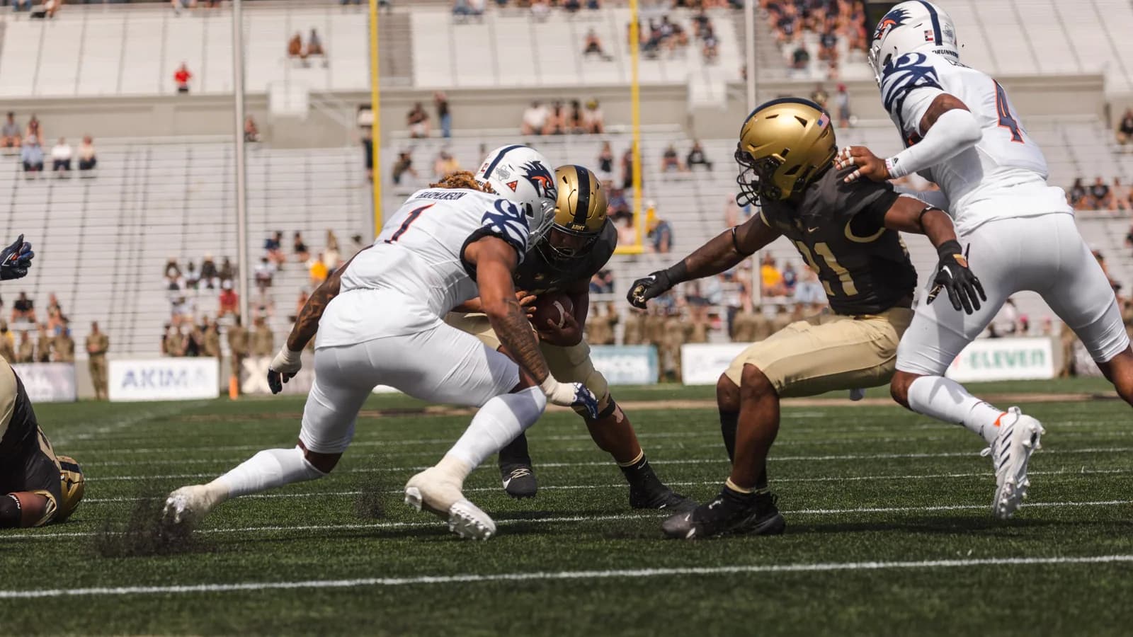 A UTSA player in white carries the ball against Army in 2022.
